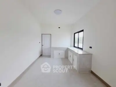 Minimalist interior room with large window and built-in storage, ideal for customization.