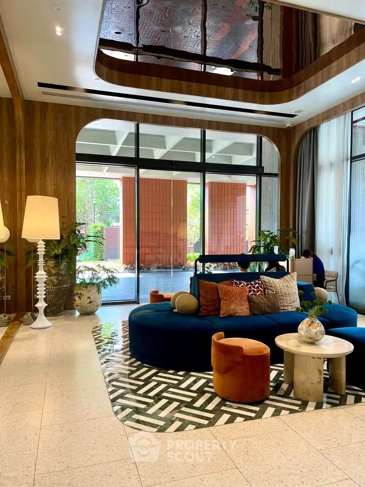 Luxurious modern living room with stylish furniture and large windows overlooking a serene garden.