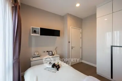 Modern bedroom with sleek design and ample natural light