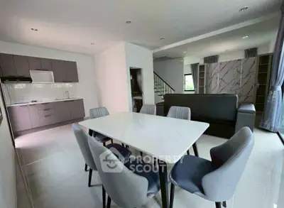 Modern open-plan living and dining area with sleek kitchen design