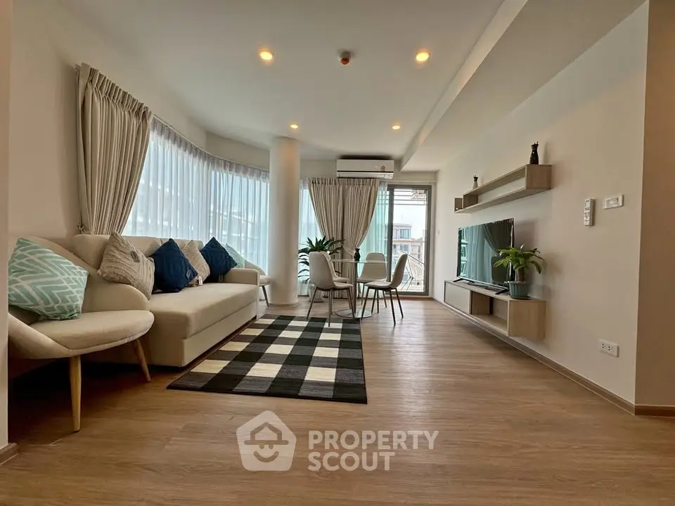 Spacious modern living room with elegant decor and large windows
