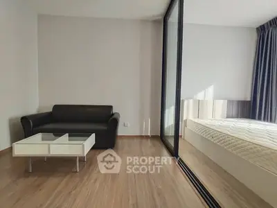 Modern minimalist bedroom with glass partition and sleek furnishings