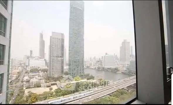 Stunning cityscape view from high-rise window overlooking river and skyline.