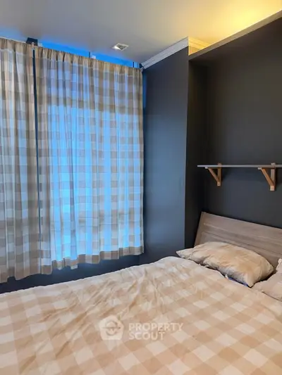 Cozy bedroom with checkered curtains and bedding, featuring a wooden shelf and soft lighting.