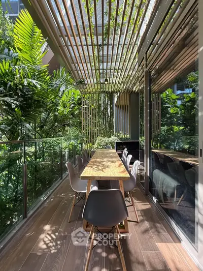 Luxurious outdoor dining area with lush greenery and modern design