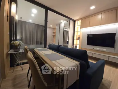 Modern living room with sleek furniture and ambient lighting in a stylish apartment.