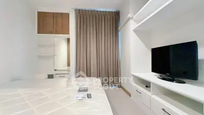 Modern bedroom with built-in storage and TV unit, featuring neutral tones and ample natural light.
