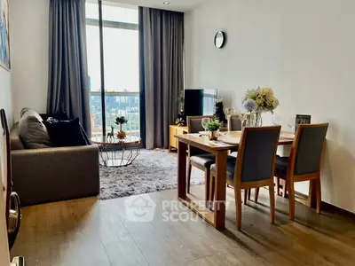 Modern living room with dining area and large window offering city views.