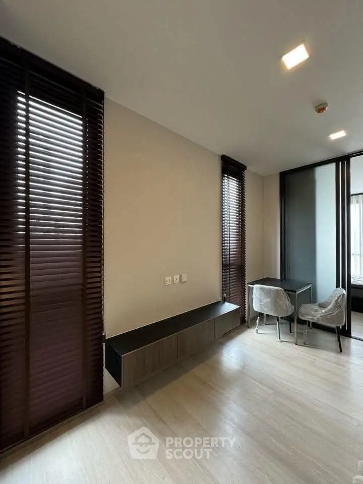 Modern study room with sleek design and natural light, featuring a minimalist desk and stylish chairs.