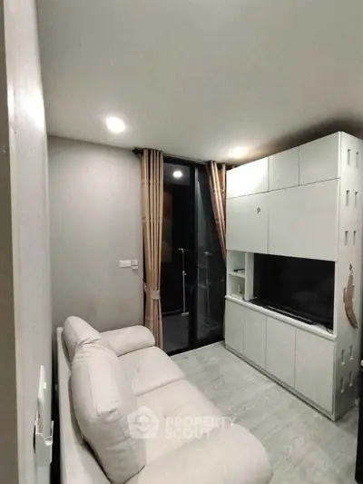 Modern living room with sleek furniture and balcony access