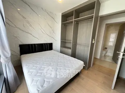 Modern bedroom with built-in closet and marble accent wall