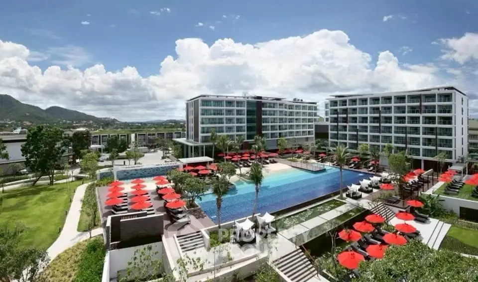 Luxurious resort with stunning pool and modern architecture under a clear blue sky.