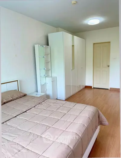 Spacious bedroom with modern furniture and ample storage space