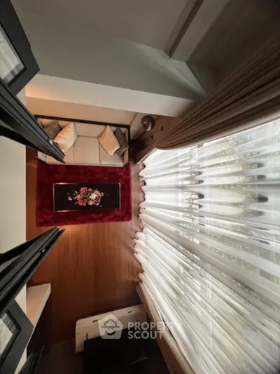 Stylish living room with plush sofa and elegant curtains, perfect for modern comfort.