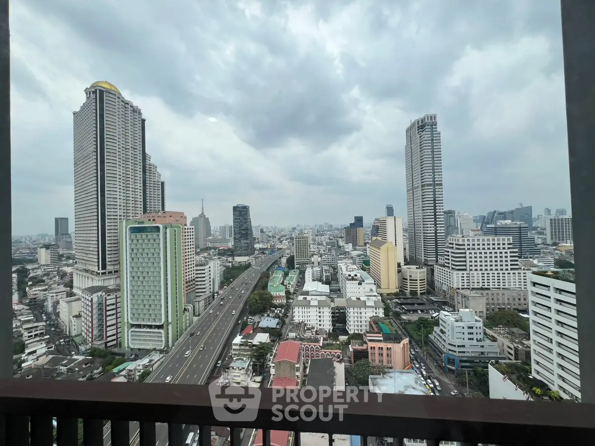 Stunning cityscape view from a high-rise balcony overlooking urban skyline.