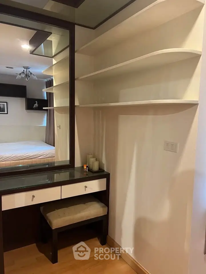 Elegant bedroom with built-in vanity and shelving, featuring modern design and ample storage space.