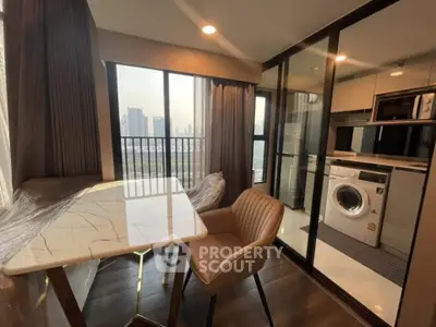 Modern apartment with stylish dining area and laundry facilities, featuring city views.