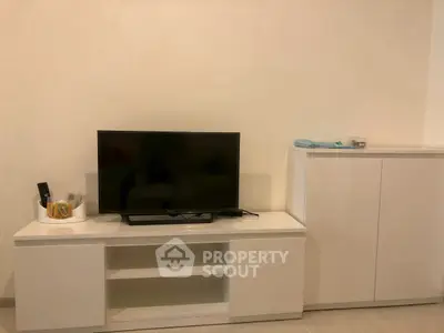 Modern living room with sleek white TV stand and cabinet