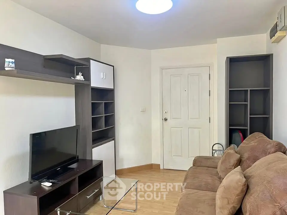 Cozy living room with modern furniture and ample storage space.