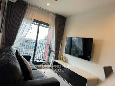 Modern living room with sleek TV setup and city view balcony.
