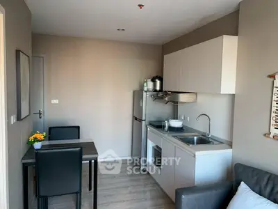 Modern compact kitchen with dining area in cozy apartment