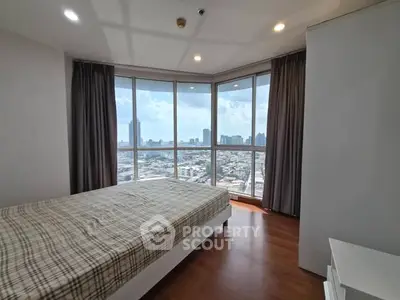 Spacious bedroom with panoramic city view and large windows