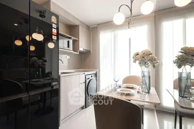 Modern kitchen with sleek appliances and elegant dining area, featuring stylish lighting and floral decor.