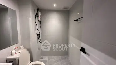 Modern bathroom with sleek gray tiles and shower area