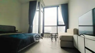 Modern bedroom with large windows and city view, featuring a cozy bed and stylish furniture.