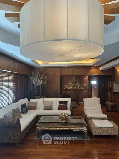 Luxurious living room with elegant wooden decor and plush seating in a sophisticated home.
