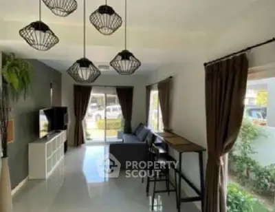 Spacious living room with modern decor and large windows for natural light.