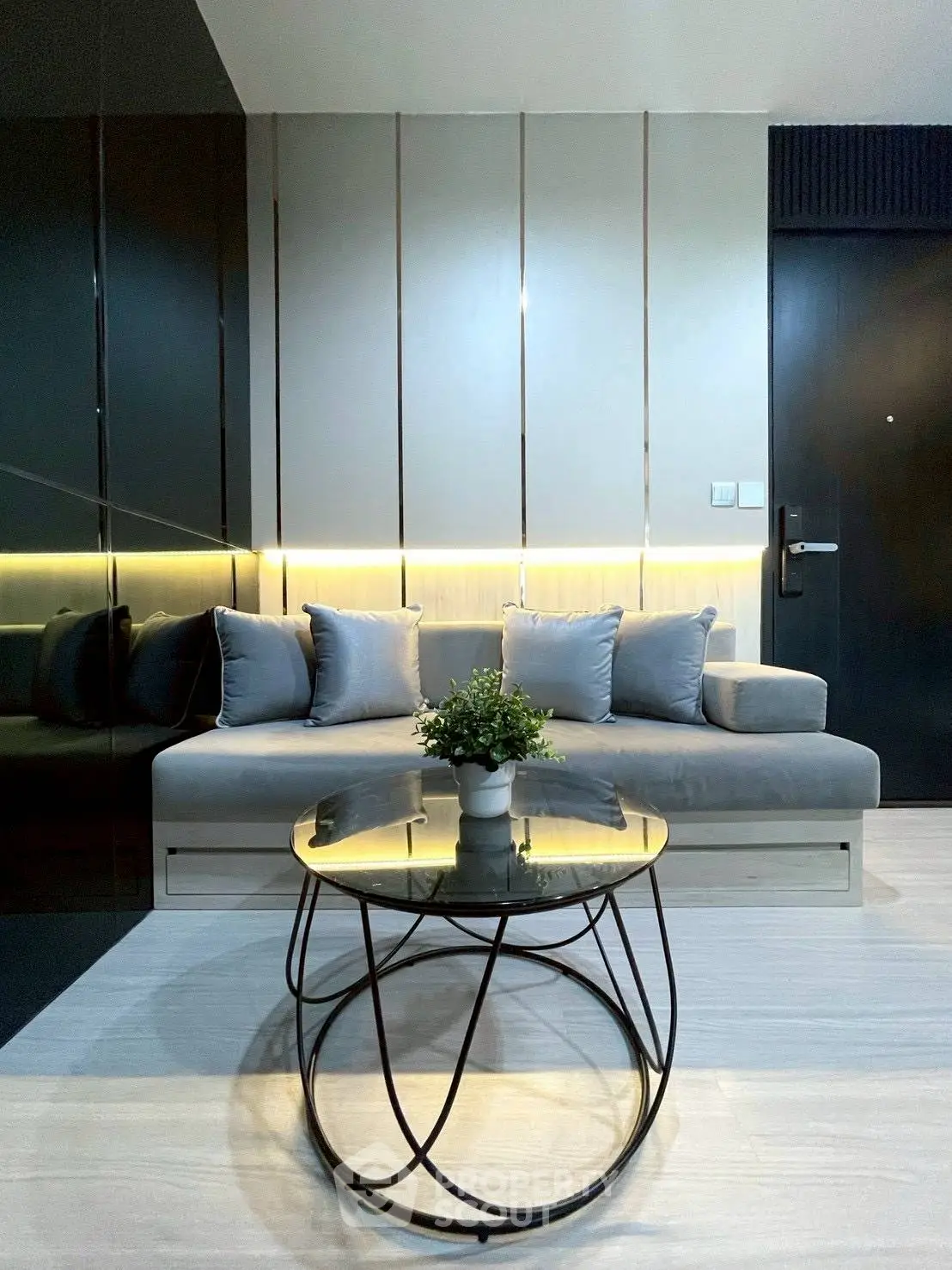 Modern living room with sleek design, featuring a stylish sofa and elegant coffee table.