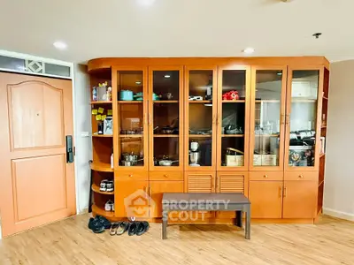 Spacious living room with elegant wooden cabinet and modern decor