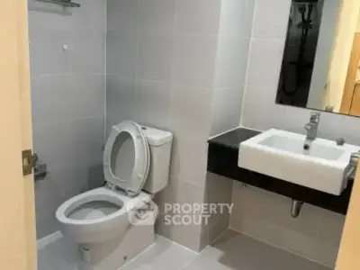 Modern bathroom with sleek fixtures and neutral tiles, perfect for a contemporary home.