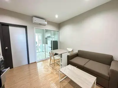 Modern living room with sleek furniture and open kitchen layout