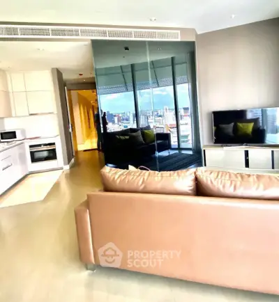 Modern living room with city view, sleek kitchen, and stylish leather sofa