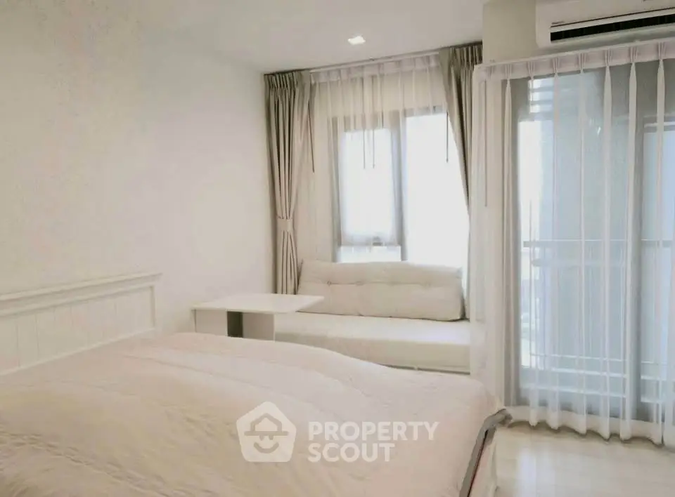 Bright and cozy bedroom with large window and elegant curtains in modern apartment.