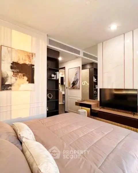 Modern bedroom with stylish decor and built-in storage, featuring a cozy ambiance.