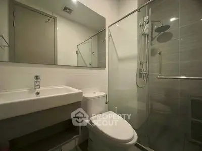 Modern bathroom with sleek fixtures and glass shower enclosure