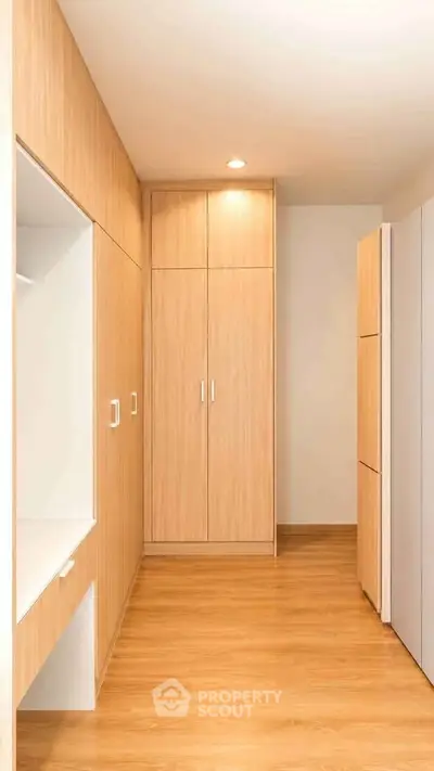 Modern storage room with sleek wooden cabinetry and ample space.