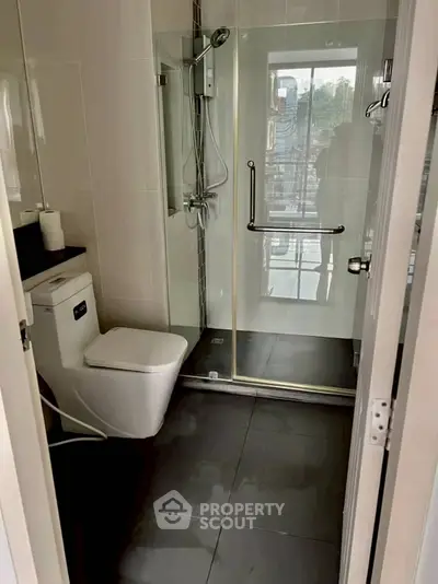 Modern bathroom with glass shower enclosure and sleek fixtures