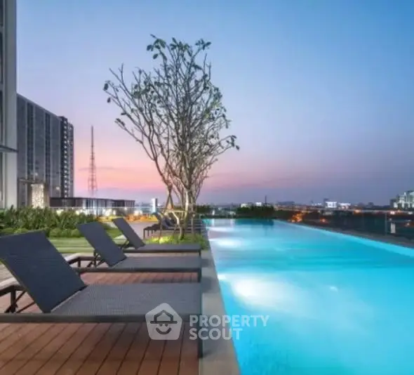 Luxurious rooftop pool with stunning city skyline view at sunset.