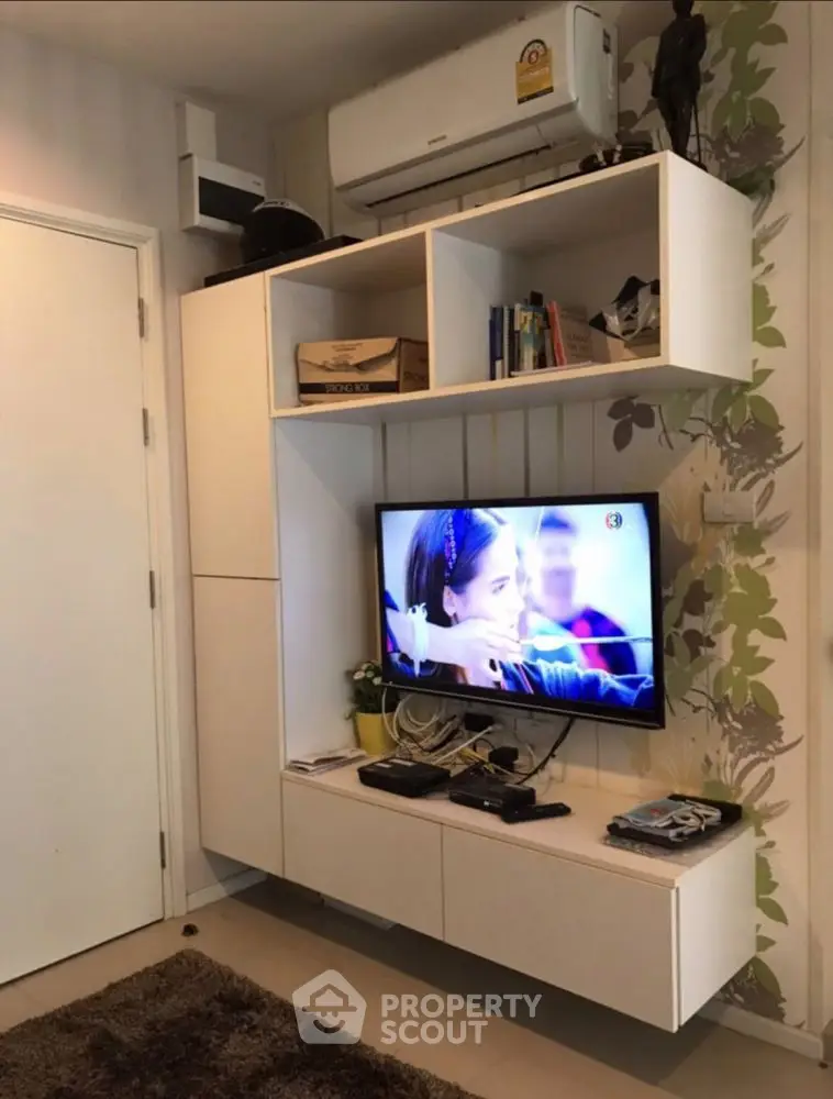 Modern living room with wall-mounted TV and stylish storage units