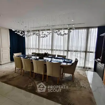 Luxurious dining room with elegant chandelier and floor-to-ceiling windows