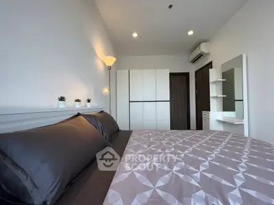 Modern bedroom with sleek design, featuring a comfortable bed, stylish wardrobe, and elegant lighting.