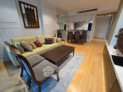 Spacious living room with elegant decor and open layout, featuring hardwood floors and modern furniture.