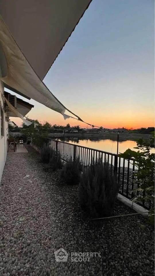 Stunning lakeside view from a serene backyard at sunset, perfect for relaxation.