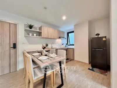 Modern kitchen with dining area featuring sleek wooden cabinets and contemporary decor.