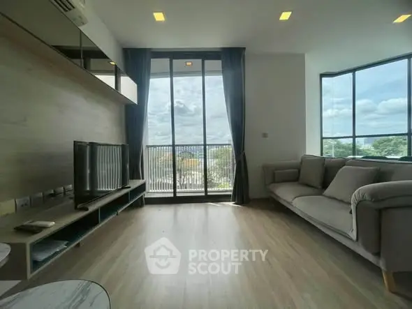 Spacious living room with large windows and modern decor offering stunning views.