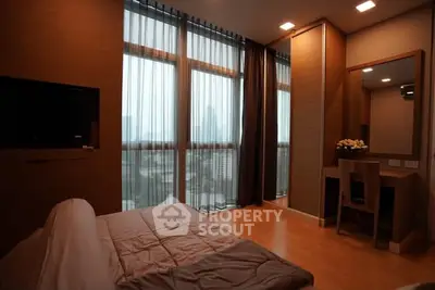 Luxurious bedroom with floor-to-ceiling windows and city view, featuring modern decor and cozy ambiance.